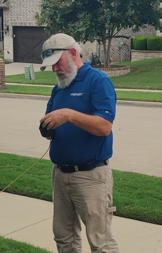 House Fluent inspector taking measurements on-site during a foundation inspection